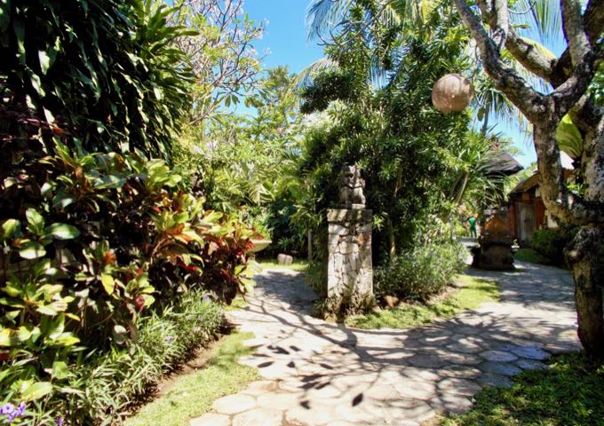 Stone paths lead to bungalows among the beautiful gardens.