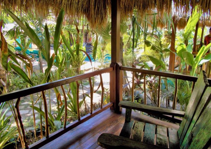 Accommodations feature wooden patios with outdoor furniture.