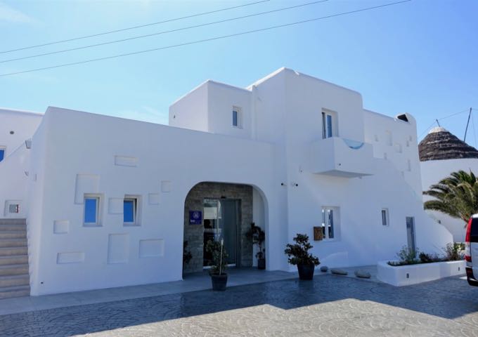 The hotel features a traditional Cycladic design.