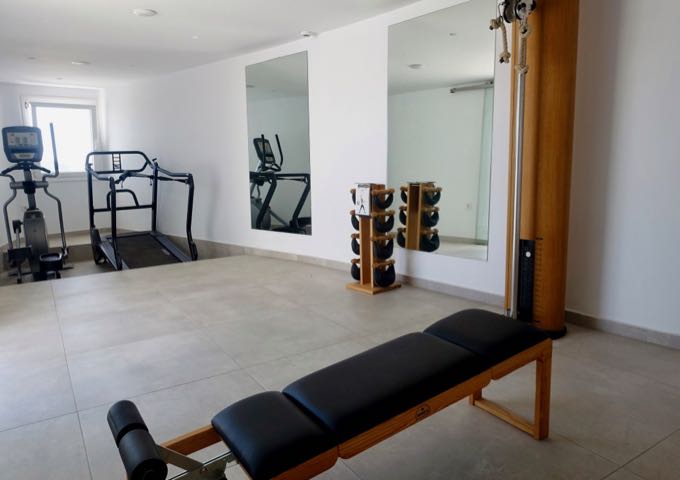 The hotel gym is small, modern, and bright.