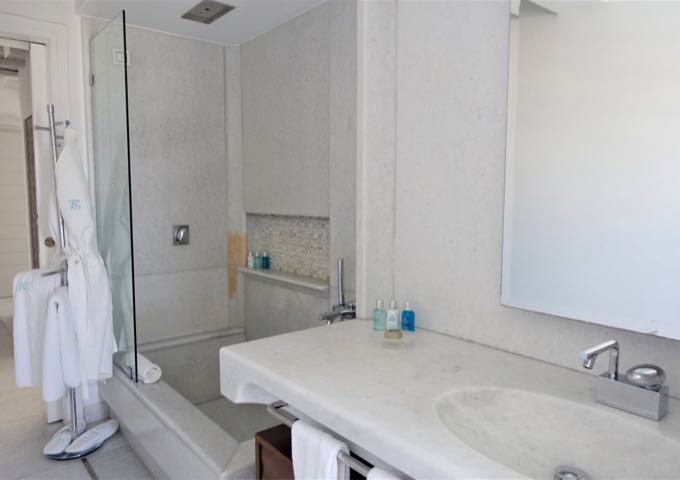 The room has a large, ensuite marble bathroom with a rainfall shower.