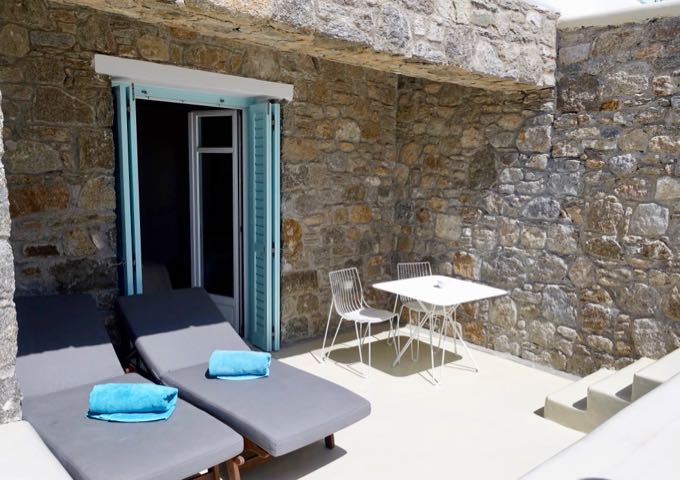 The private terrace comes with a small dining table and 2 sunbeds.