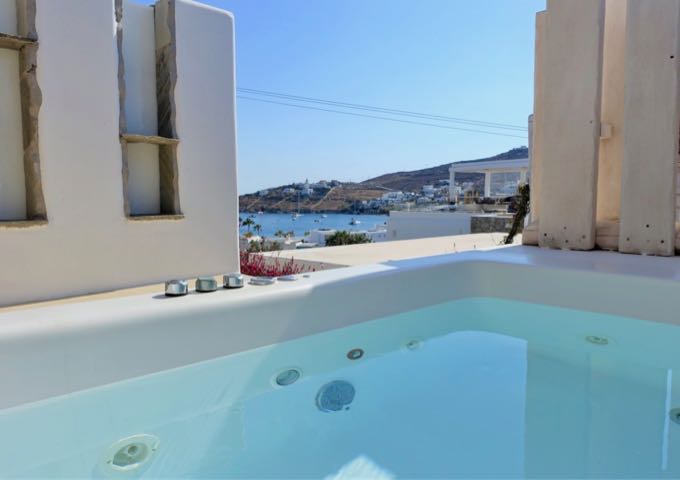 The outdoor jacuzzi offers views of Ornos.