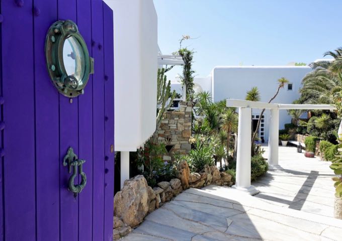 The hotel entrance is marked by a striking purple door.