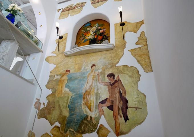 The hotel lobby has a large Grecian mural in the stairway.