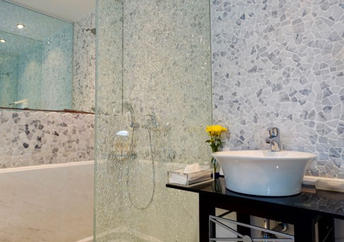 The suite's bathroom also has a marble and glass shower.