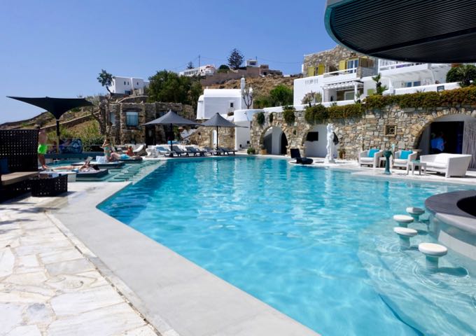 The main saltwater pool has a swim-up bar and glass sun loungers.