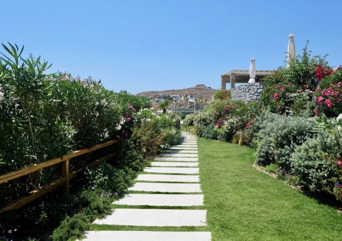 A path through Mykonos' greenest gardens leads to the beach.