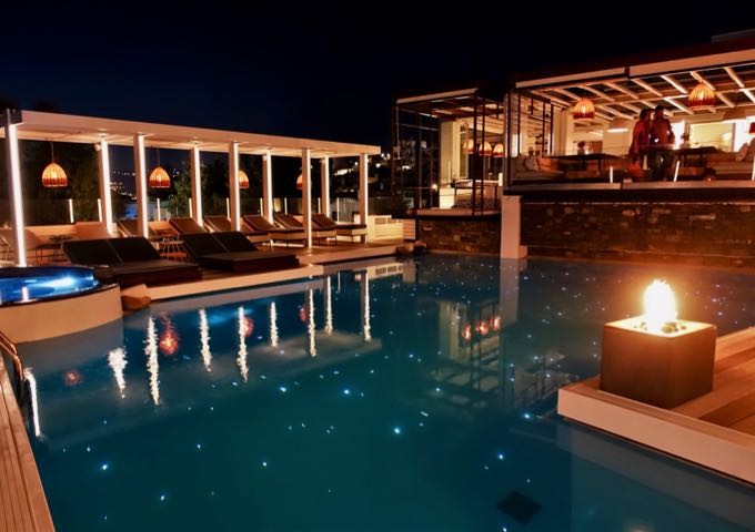 There is romantic lighting at night by the pool.