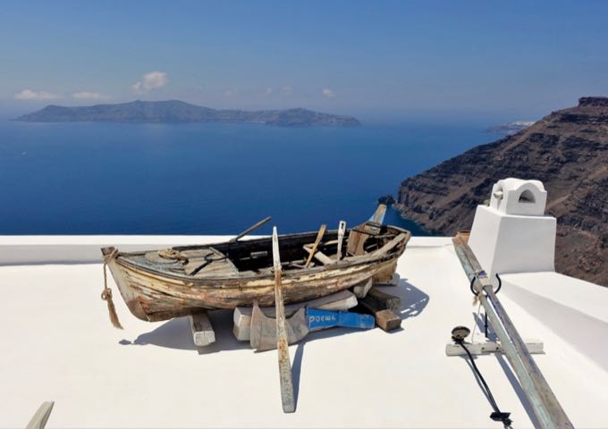 The hotel entrance is marked by a boat, and offers panoramic views from Thirassia Island to Oia village.