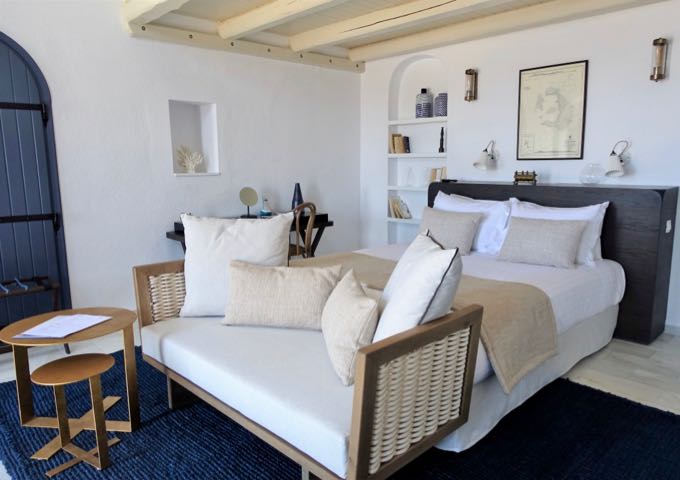 The main bedroom features a contemporary, Cycladic-style architecture with a blue and white palette.