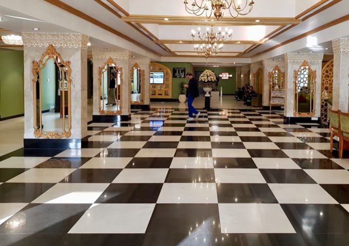 The lobby's marble tiles and columns boast of historical splendor.