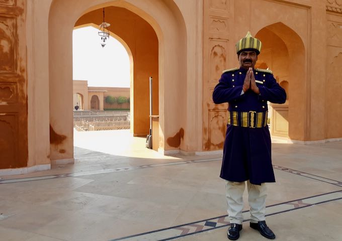 The traditionally-dressed doorman welcomes the guests.