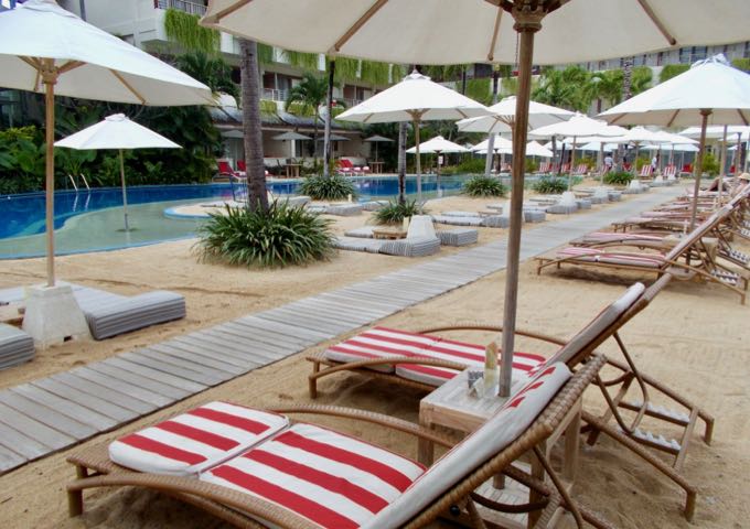 The pools feature sandy areas with lounge chairs.