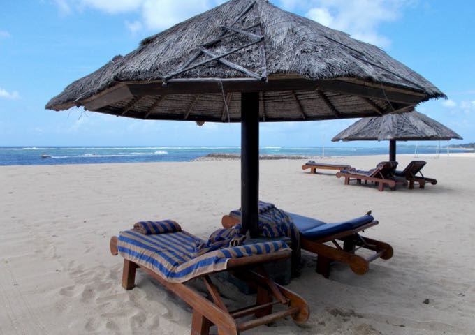 There are plenty of lounge chairs and thatched umbrellas on the beach provided by the resort.
