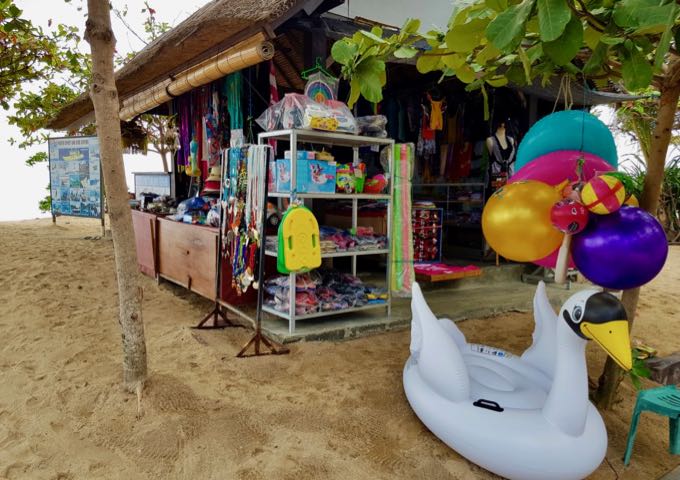 Souvenirs and beach equipment is sold at beachside stalls.