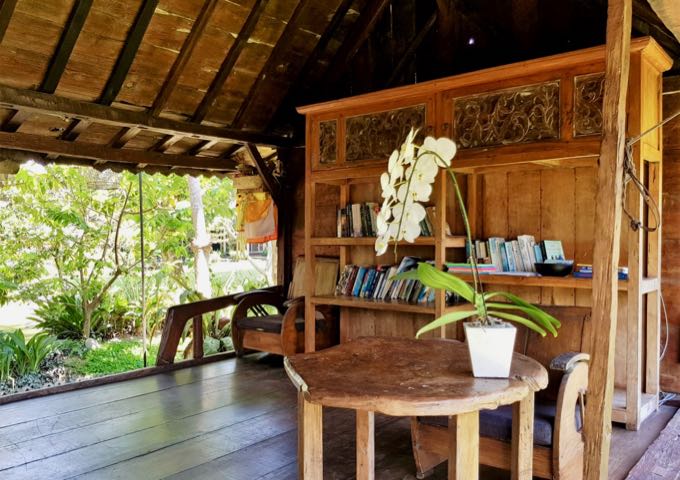 The traditional huts in the resort grounds includes one with a small library.