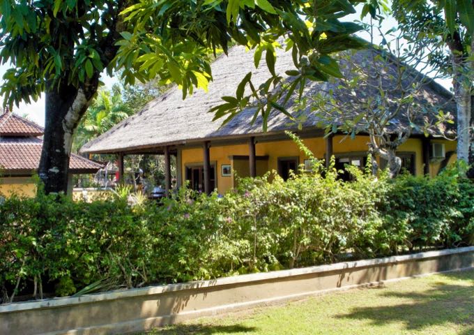 The traditionally-designed villas feature thatched roofs and broad verandas.