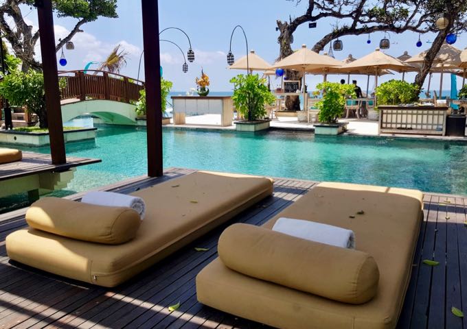 The wooden pool decks feature comfortable daybeds.