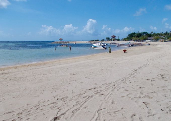 The magnificent beach in front of the resort features white sand and blue water.
