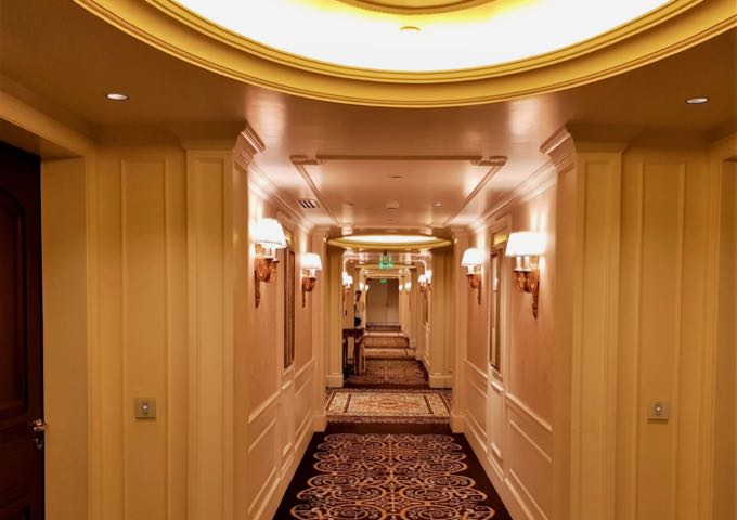 The corridors are designed with wood paneling and plush carpets.