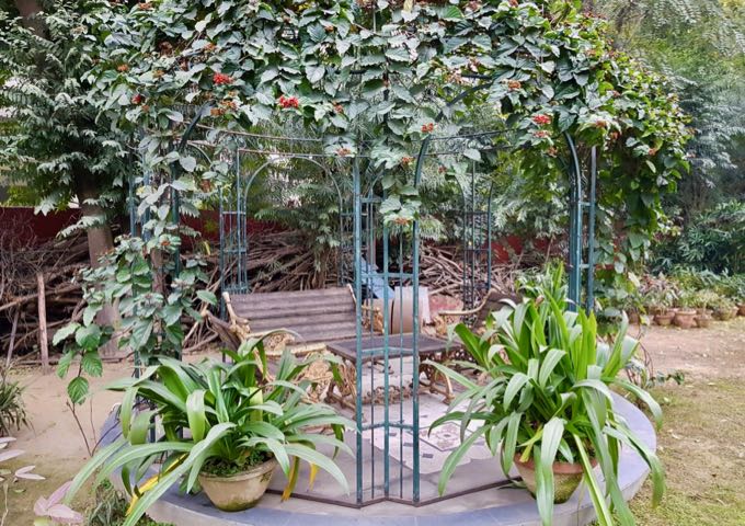 The garden features a shady sitting area.