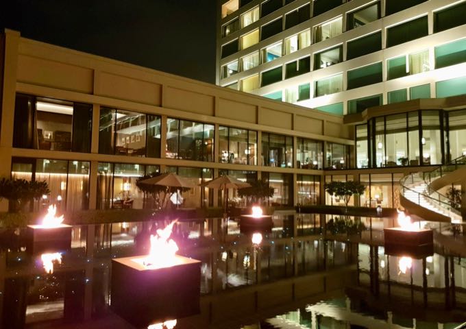 It features a reflection pool illuminated at night with flames.