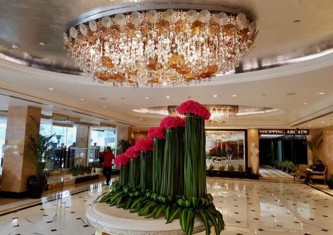 The opulent lobby features marble flooring and a huge chandelier.