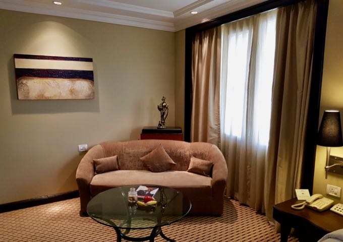 The spacious suites feature chairs with footstools and sofas.