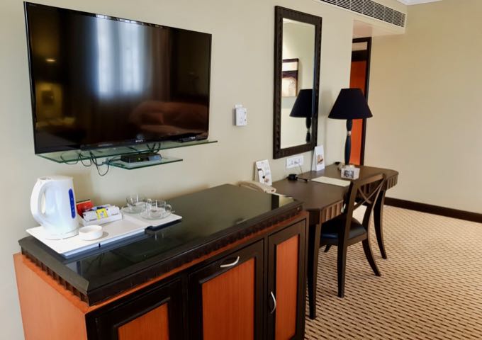 The gorgeous suites feature dark wooden furniture.
