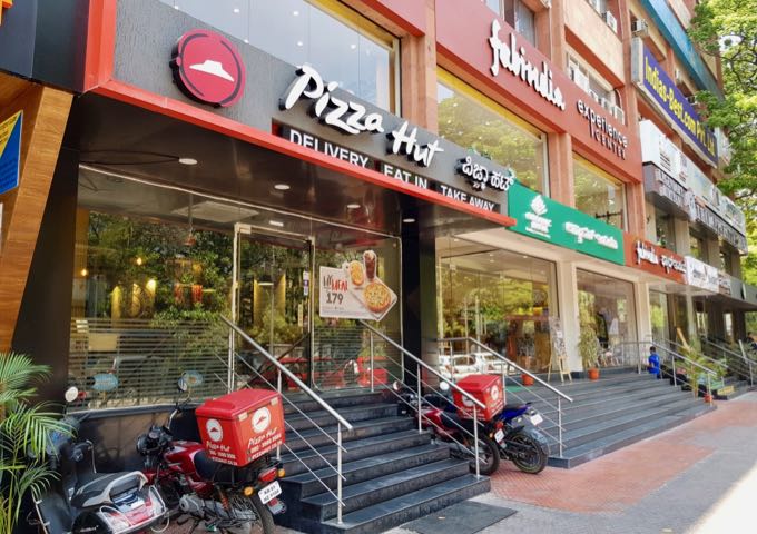One can find a Pizza Hut and Starbucks among several cafés and shops on M.G. Road.