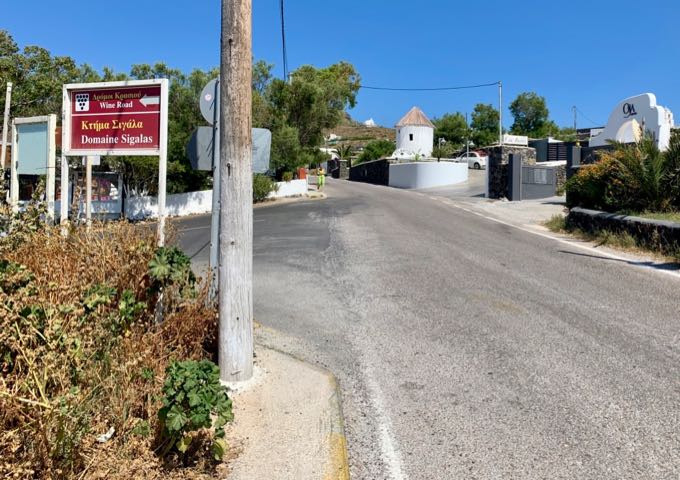 Street sign in Oia, pointing the way to Domaine Sigalas winery