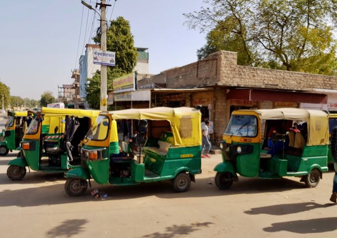 The neighborhood has a lot of auto-rickshaws.