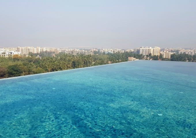 The rooftop pool has infinity edges that seem to merge into the horizon.