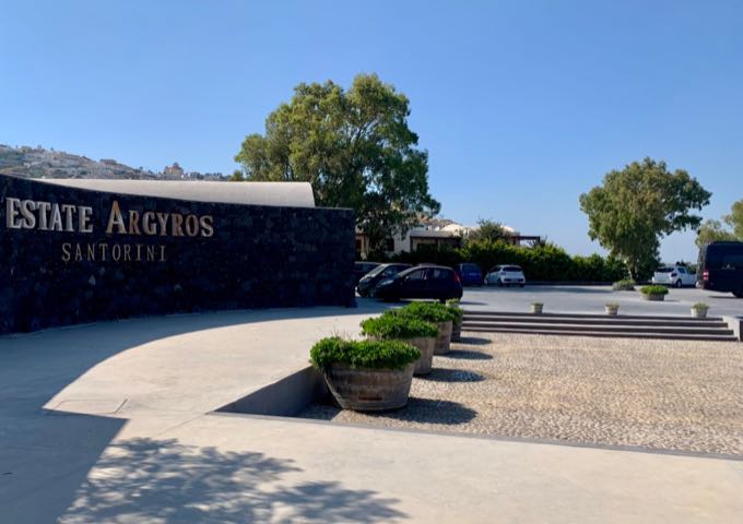 Parking lot next to the sign for Estate Argyros winery