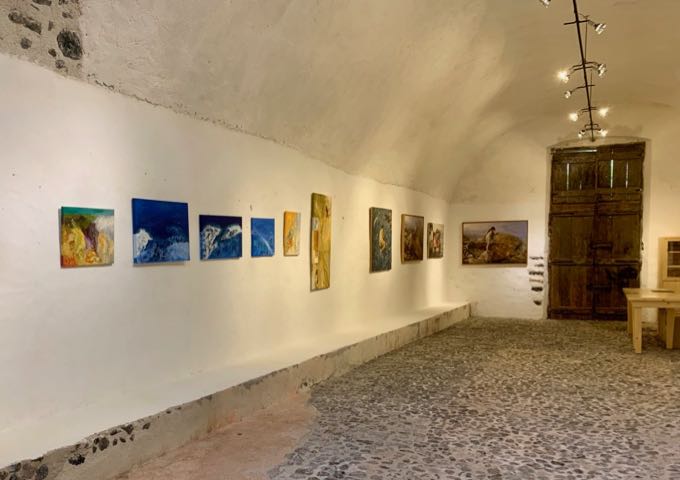 Paintings displayed along the wall of a cave