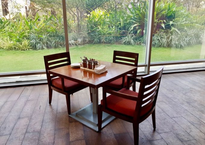 Some tables at Spice Haat offer garden and pool views.