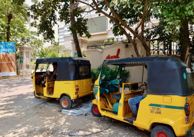 Several auto-rickshaws can be found in the area.