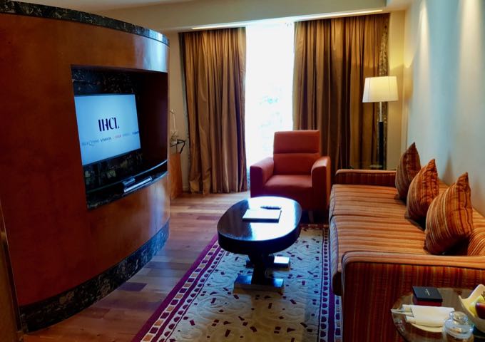 A divider with a TV on either side separates the living and sleeping areas in the suites.