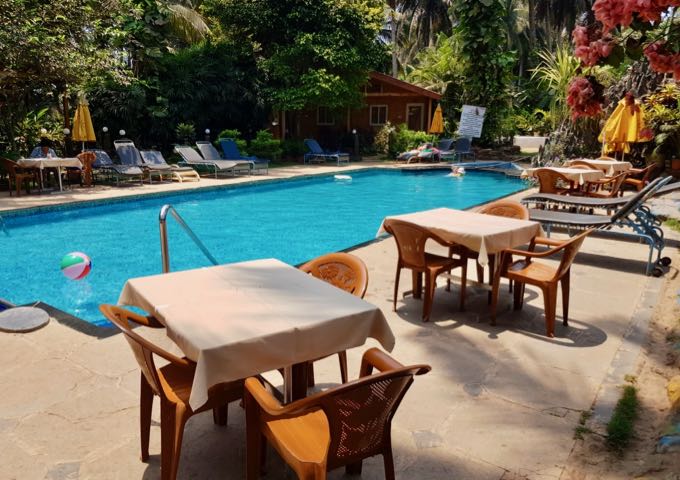 Guests can enjoy drinks or meals by the pool.