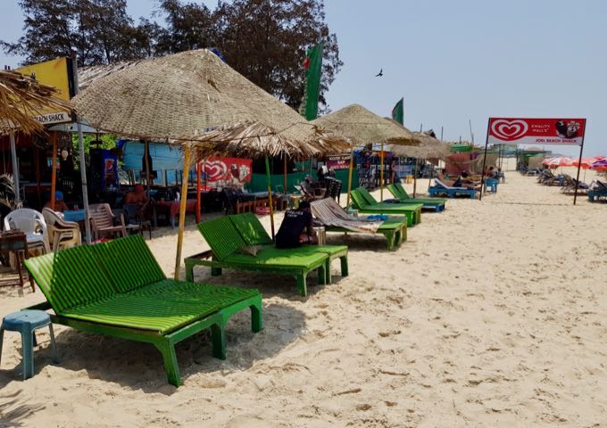 Shacks rent out sunbeds with thatched umbrellas.