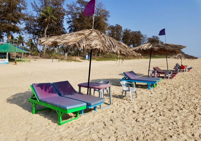The uncrowded beach features sunbeds on rent.