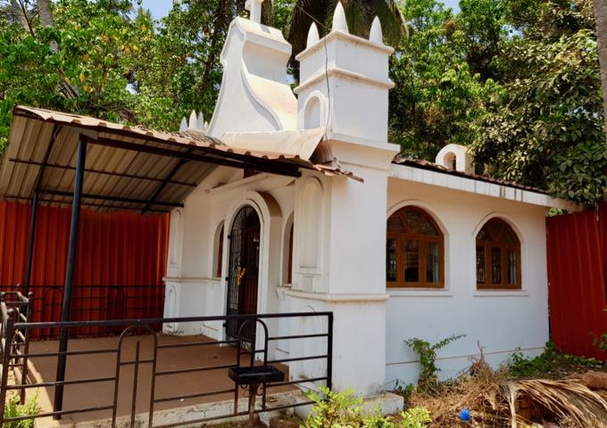 An iconic Goan church is by the riverside road.