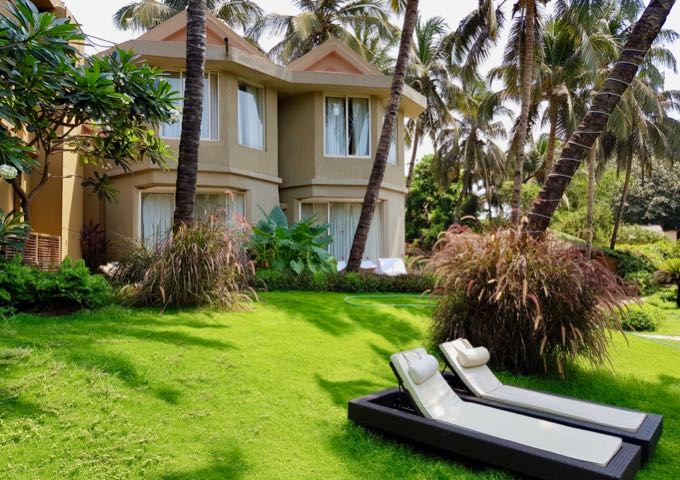 Villas offer sunbeds on the grass outside.