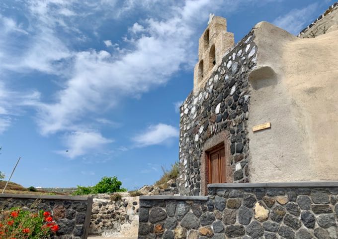 Stone chapel built into a Santorini hillside