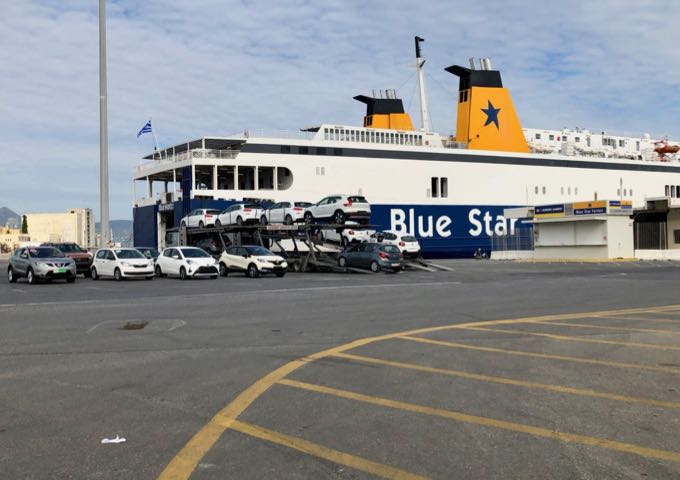 Blue Star ferry docked in port next to a closed ticket booth.