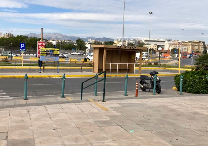 Empty covered taxi stand in a parking lot.