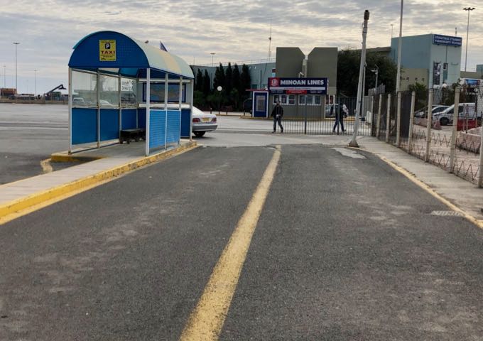 Covered taxi stand in a parking lot.
