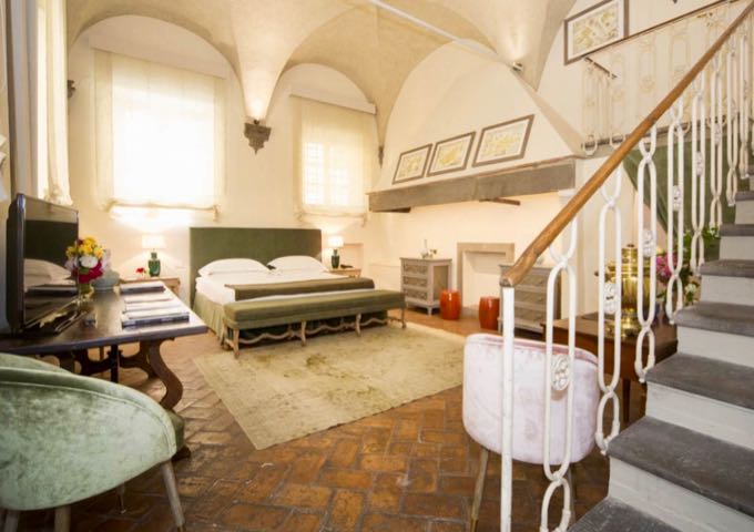 Elegant hotel suite with sitting area, coved ceilings, and stairway