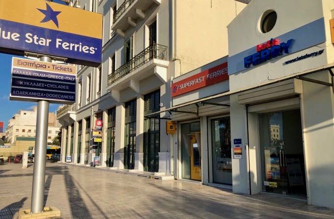 Ferry ticket office storefronts in Piraeus port.
